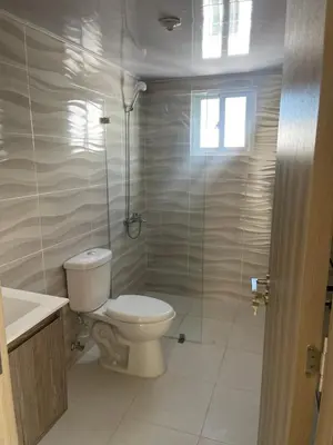 a bathroom with a toilet and a glass shower at casa Martinez refugio sereno in Santiago de los Caballeros