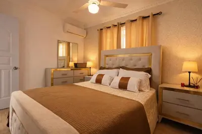 a bedroom with a large bed and a ceiling fan at casa Martinez refugio sereno in Santiago de los Caballeros