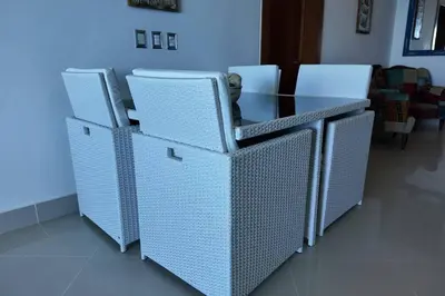 a glass table and chairs in a room at Beachfront Cabarete Apartment in Cabarete