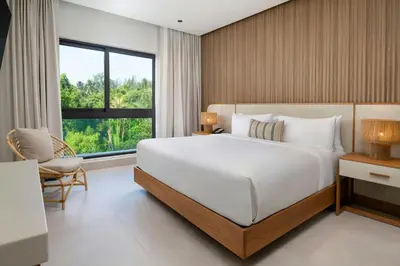 a bedroom with a large white bed and a window at Donoma Las Terrenas Beach Hotel & Spa, Autograph Collection in Las Terrenas