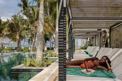 a woman laying on a towel next to a swimming pool at Donoma Las Terrenas Beach Hotel & Spa, Autograph Collection in Las Terrenas