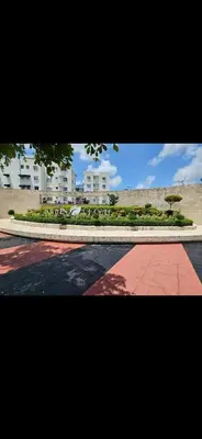 a view of a park with a building and a tree at Apartamento con terraza y jacuzzi privado in Santo Domingo