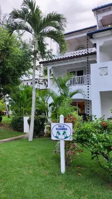 a sign in front of a house with a palm tree at Caribe Home Dominicus Oleandra 3 in La Laguna