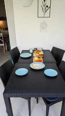 a black table with blue plates and food on it at Caribe Home Dominicus Oleandra 3 in La Laguna