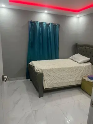 a bedroom with a bed with a blue curtain at Sol tropical in La Grúa