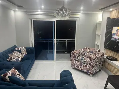 a living room with a blue couch and two chairs at Sol tropical in La Grúa