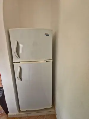 a white refrigerator in a corner of a room at Apts dentro de Residencial Soficu Eden in La Laguna
