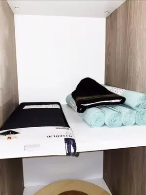 a shelf with towels and a printer on it at Luxury Santo Domingo Tower Condo in Santo Domingo