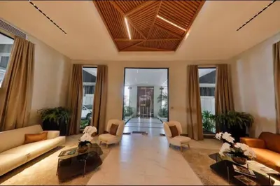 a living room with a couch and chairs and windows at Luxury Santo Domingo Tower Condo in Santo Domingo