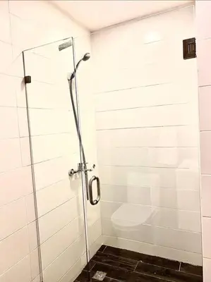 a shower stall with a toilet in a bathroom at Luxury Santo Domingo Tower Condo in Santo Domingo