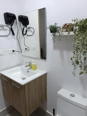 a bathroom with a sink and a mirror and a toilet at Boca del Mar III, apartamento 411 in Boca Chica