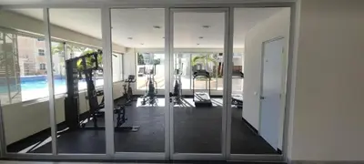 an empty gym with glass doors and a swimming pool at Boca del Mar III, apartamento 411 in Boca Chica