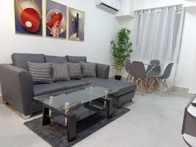 a living room with a couch and a table at Boca del Mar III, apartamento 411 in Boca Chica