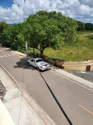 a white truck parked on the side of a road at The Loft Bayaguana in Bayaguana