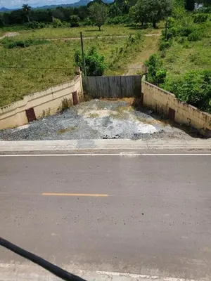 a road with a retaining wall next to a street at The Loft Bayaguana in Bayaguana