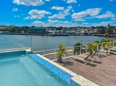 a swimming pool on the roof of a building next to a river at BEST Studio, Pool & Gym, River view from terrace in Calero