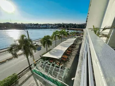 a balcony of a building with palm trees and a street at BEST Studio, Pool & Gym, River view from terrace in Calero