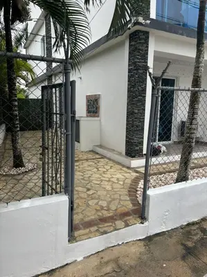a fence in front of a house with a yard at Apartment, Close to the Bayahibe Beach in Bayahibe