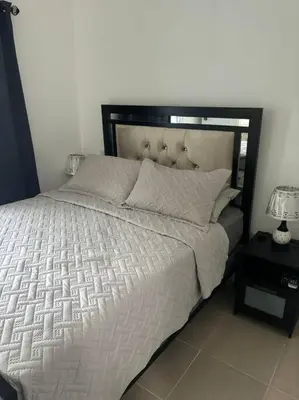 a bedroom with a large bed with a black headboard at Apartment, Close to the Bayahibe Beach in Bayahibe