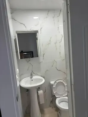 a white bathroom with a sink and a toilet at Apartment, Close to the Bayahibe Beach in Bayahibe
