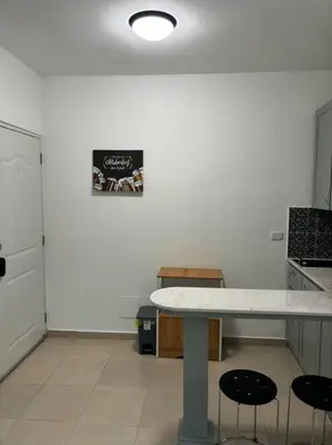a kitchen with a table and two stools at Apartment, Close to the Bayahibe Beach in Bayahibe