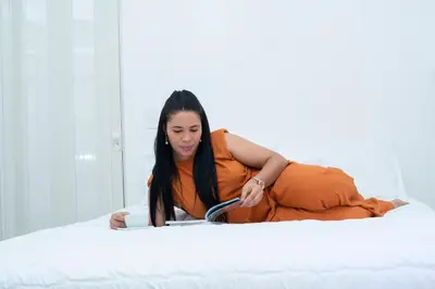 a woman in an orange dress laying on a bed at Casa de Huespedes Colonial in Santo Domingo