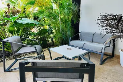 a patio with two chairs and a table at Aligio Beachfront Resort & Spa in Las Terrenas