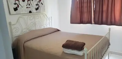 a white crib with a brown towel on it in a bedroom at Cabrera 6 in Cabrera