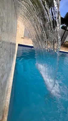 a pool of water with a dolphin in it at Crown ll-3 Bedrooms-Pool-Close to everything! in San Felipe de Puerto Plata