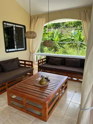 a living room with a couch and a table at Villa Karolina in Las Galeras
