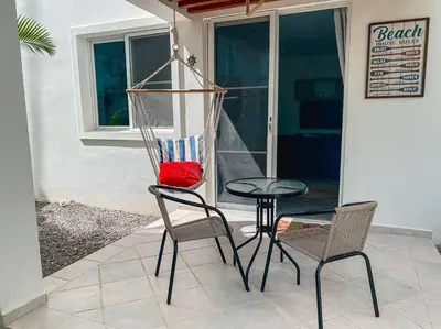 a chair and a table and two chairs and a table at 104 PL - Elegante y moderno, posición perfecta in La Laguna
