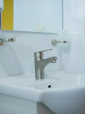 a bathroom sink with a silver faucet and a mirror at Villas Vallejuelo in Vallejuelo