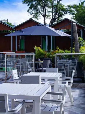 a group of tables and chairs with an umbrella at Villas Vallejuelo in Vallejuelo