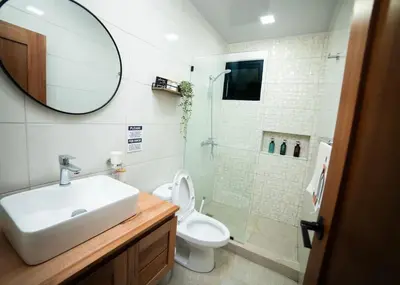 a bathroom with a toilet and a sink and a shower at Divine Stay 3 Bedroom One minute from the beach on the malecon in San Felipe de Puerto Plata