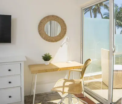 a desk with a lamp and a chair in a room at KITE BEACH HOTEL Oceanfront Apartments in Cabarete