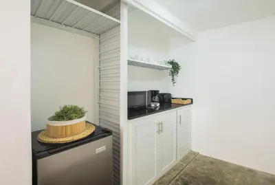a small kitchen with a counter and a microwave at KITE BEACH HOTEL Oceanfront Apartments in Cabarete