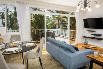 a living room with a blue couch and a table at KITE BEACH HOTEL Oceanfront Apartments in Cabarete