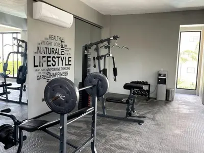 a gym with several tread machines in a room at Pool & Gym - 10min Aeropuerto y HOMS - Dream Stay in Santiago de los Caballeros