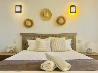 a bedroom with a bed with hats on the wall at Tropical Villa 4Bedroom 3Baths and Pool Near Beach in Las Terrenas