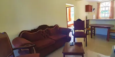 a living room with a couch and a table at Sun Sea - Costambar Beachside Apartment with Pool in San Felipe de Puerto Plata