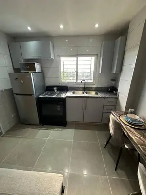 a small kitchen with a sink and a stove at Apartment in Santo Domingo este in Juan López