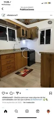 a kitchen with wooden cabinets and a stove top oven at Villa Naturaleza y confort in Santiago de los Caballeros