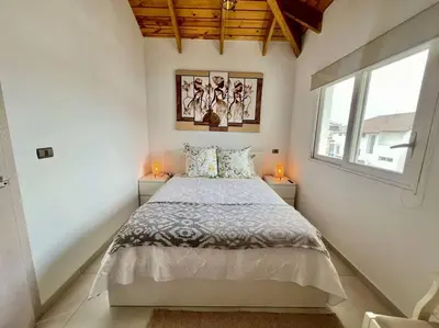 a bedroom with a large bed with two windows at AD-301 Ático Duplex Estrella Dominicus in La Laguna
