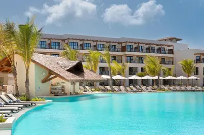 a resort with a large swimming pool with lounge chairs at Secrets Playa Esmeralda Resort & Spa - All Inclusive in Miches