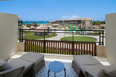 a balcony with chairs and a view of the ocean at Dreams Playa Esmeralda Resort & Spa - All Inclusive in Miches