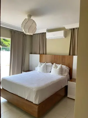 a bedroom with a large bed with white sheets at Villa familiar con vista al océano in San Felipe de Puerto Plata