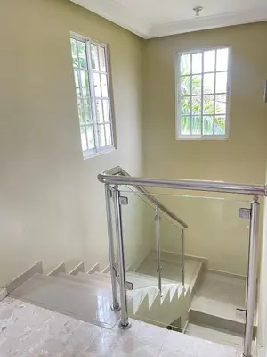 an empty room with stairs and two windows at Villa familiar con vista al océano in San Felipe de Puerto Plata