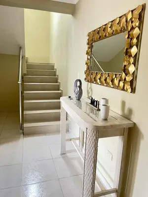 a dressing table with a mirror and a staircase at Villa familiar con vista al océano in San Felipe de Puerto Plata