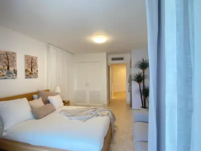 a living room with a bed and a couch at Apartamento de playa in San Felipe de Puerto Plata