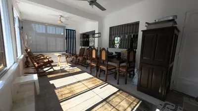 a room with chairs and a table in a room at Villa Cordero - Las Calderas Bani in Baní